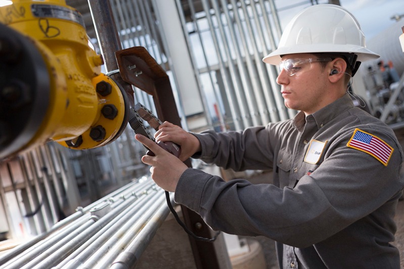 a U.S. refinery worker back on the job working on a pipeline after oilfield injuries