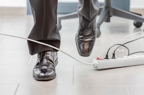 a worker about to trip on a power cable in the office, a potential premises liability case