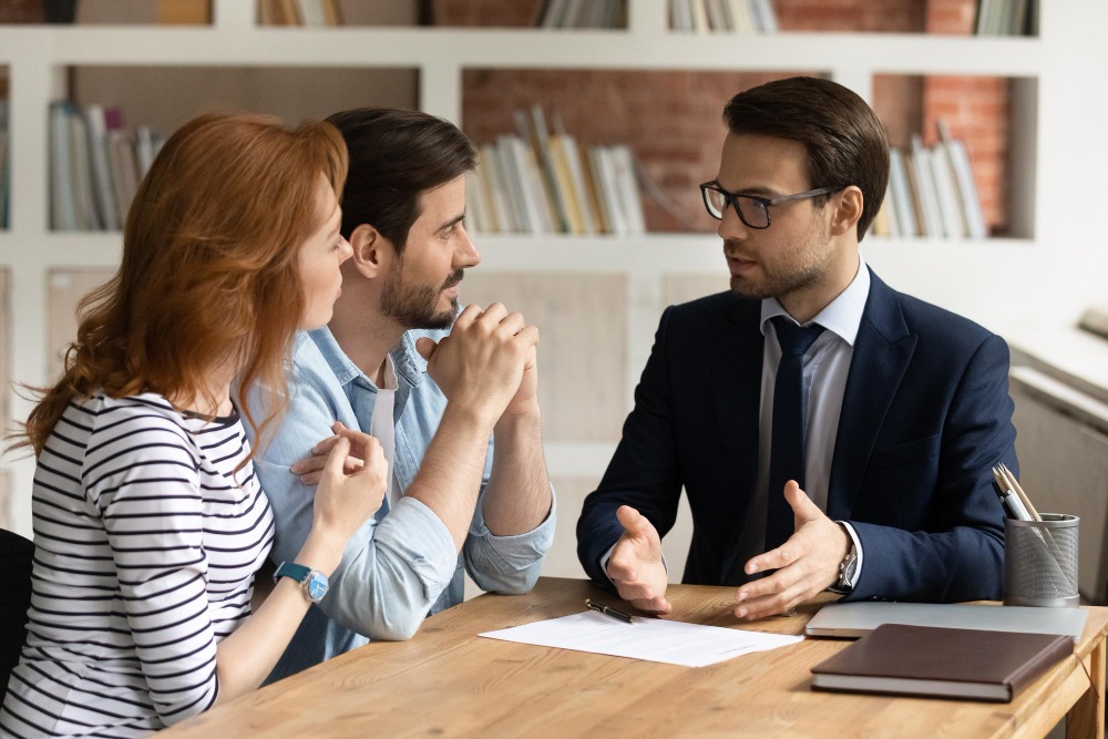 a couple sitting at a table and speaking with a personal injury attorney