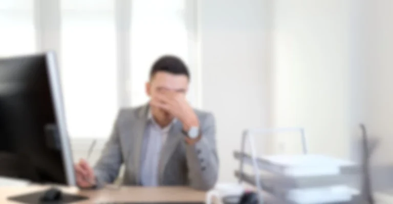 Stressed person reviewing complicated paperwork while filing injury claims without professional legal assistance